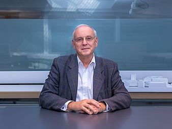 Portrait of an older man sitting at a table