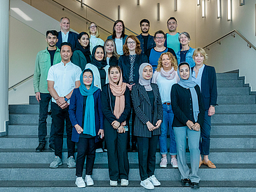 Die Stipendiat:innen mit Dr. Mandy Boehnke, Konrektorin für Internationalität, wissenschaftliche Qualifizierung und Diversität an der Universität Bremen (2. Reihe, 3. von links), Dr. Christina von Behr, Geschäftsführerin der Academy HERE AHEAD (4. Reihe, 3. von links), Dr. Marejke Baethge-Assenkamp, Leiterin des International Office der Universität Bremen (4. Reihe, 2. von links), Dr. Heike Tauerschmidt, Leiterin des International Office der Hochschule Bremen (3. Reihe rechts), Christoph Haasler, stellvertretender Geschäftsführer des Studierendenwerks Bremen (4. Reihe links) sowie weiteren Mitarbeitenden der Academy HERE AHEAD.