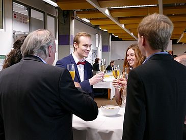 Picture of People standing by a Table and talking