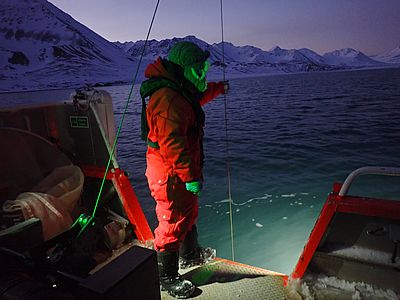 Water sampling with a niskin bottle in the Polar Night, Svalbard