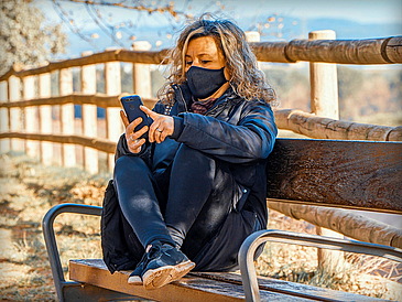 Woman smartphone benche face mask