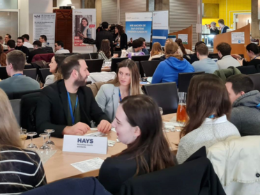Multiple students sitting at tables.