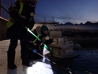 Sampling plankton with a hand net in the Polar Night, Svalbard