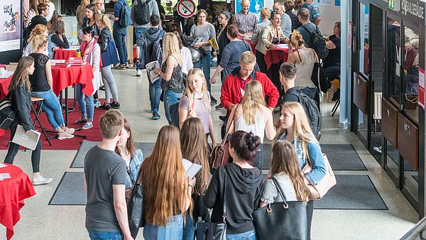 The GW2 building with stands and young people.