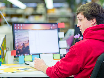 Eine Person arbeitet an einem Computer.