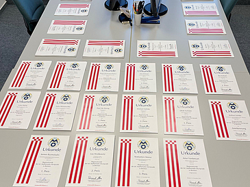 A picture of all the certificates spread across a table.