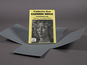 A picture of the little book Carmen Nova. It's a slim paperback with a yellow cover and a picture of a woman on the cover in black and white.