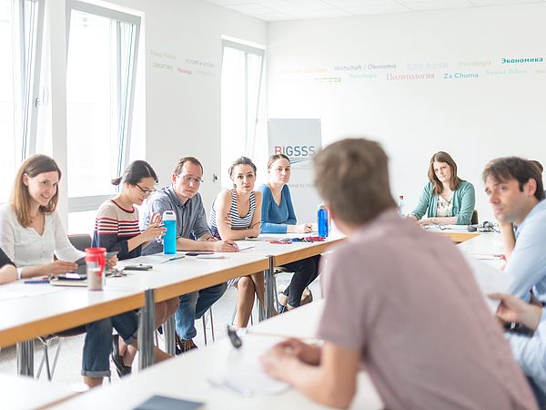 People in conversation in a seminar room.