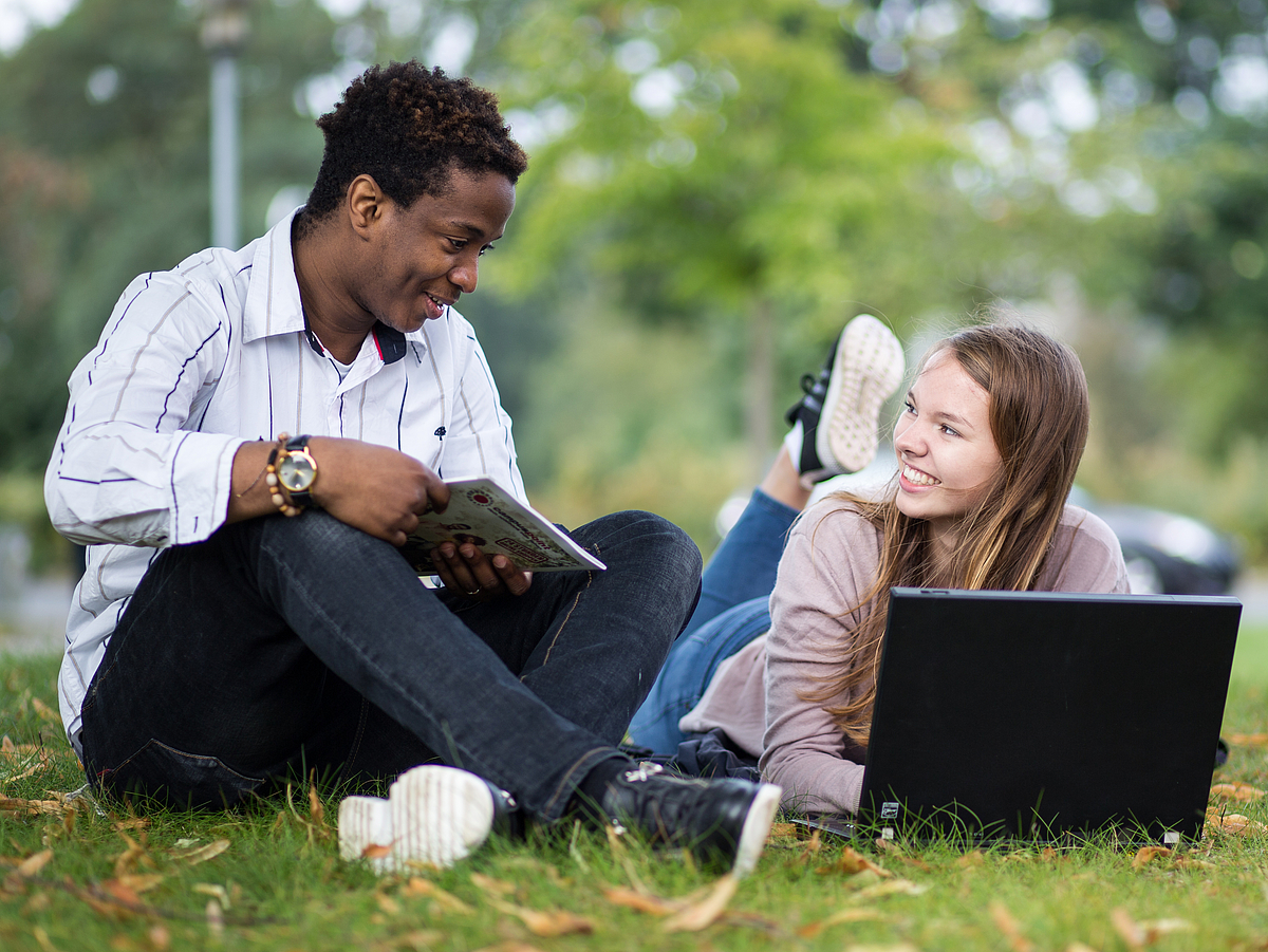 Two students working on a laptop.