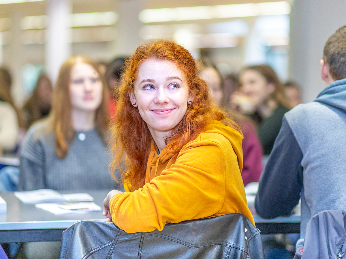 A student in focus at an information session during orientation week