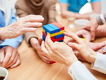 Hands on a table with building blocks