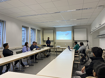 People listening to the presentation of a student