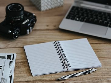 Black-and-white_photos_with_a_silver_laptop__a_notebook_and_a_camera
